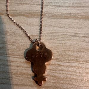 The giving key Pendant Necklace with 'Love' Inscription